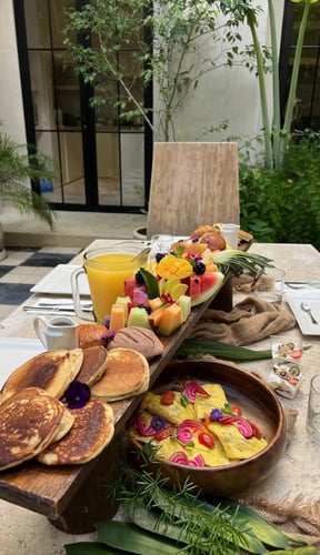 Chef plating a gourmet meal at a villa dining table