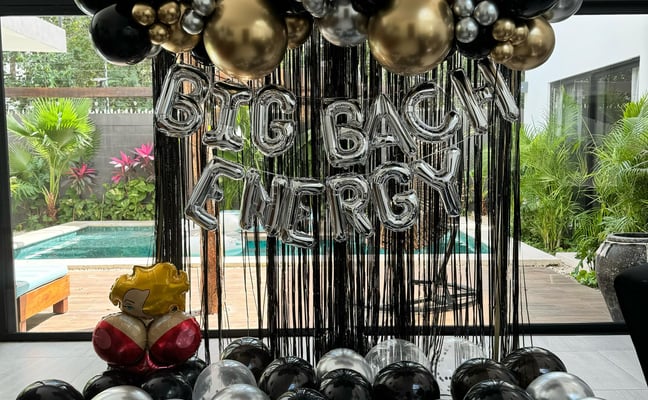 Bedroom decorated for birthday with gold and silver balloons