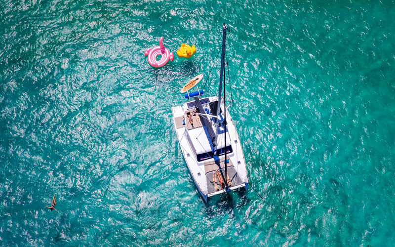 Guests on catamaran deck with open bar